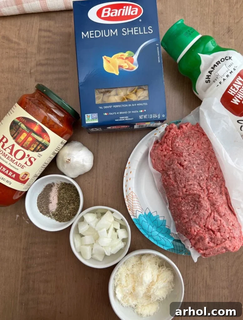 Ingredients for creamy shells and beef: shell pasta, ground meat, marinara sauce, heavy cream, Parmesan, and seasonings.