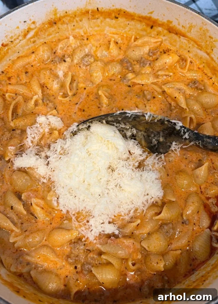Stir heavy cream and Parmesan cheese into the ground beef pasta for a creamy sauce.