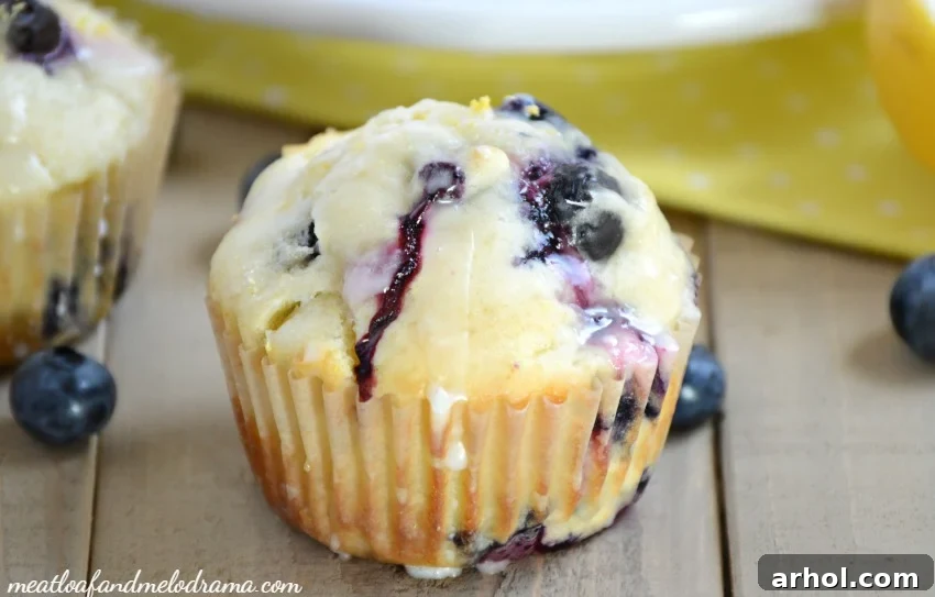 A festive breakfast spread featuring glazed lemon blueberry muffins, fresh berries, and coffee.