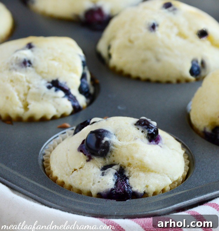 Freshly baked lemon-blueberry muffins with a delicate lemon glaze.