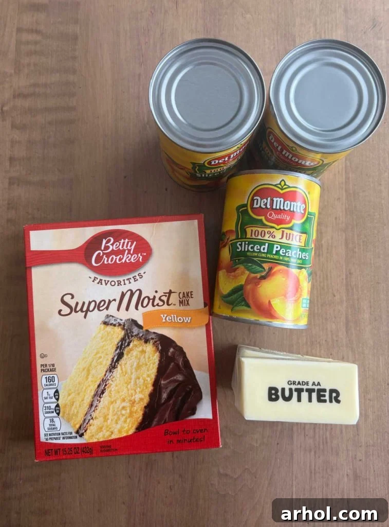 A visual of the three main ingredients: a box of yellow cake mix, cans of peaches, and a stick of butter.