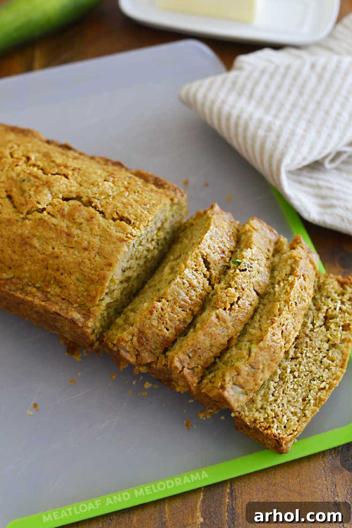 Perfectly sliced old fashioned zucchini bread on a cutting board, showcasing its moist texture and golden crust, ready to be served.