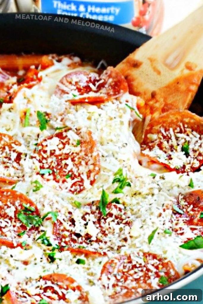 The full skillet of bubbling, cheesy pepperoni pizza pasta, adorned with melted cheese and crisp pepperoni slices, ready to be served and enjoyed.