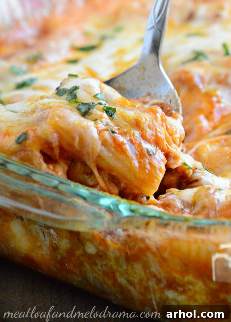 Close-up of baked rigatoni with sausage, cheese, and a sprinkle of fresh parsley