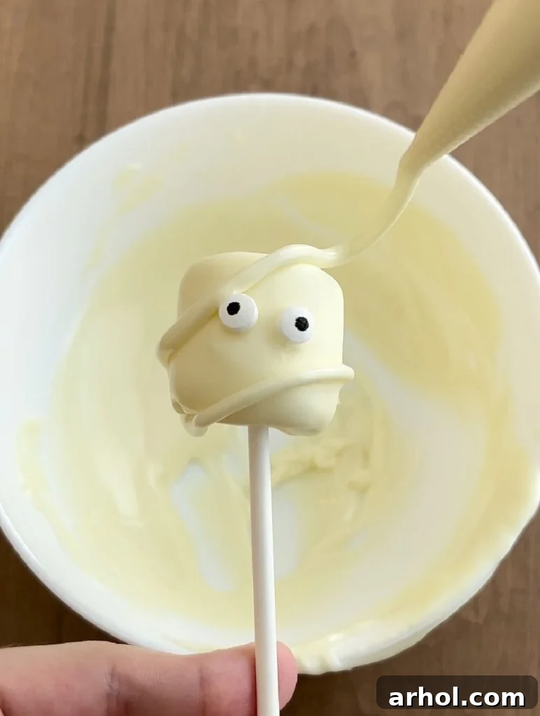 make mummy marshmallow pop with melted white chocolate.