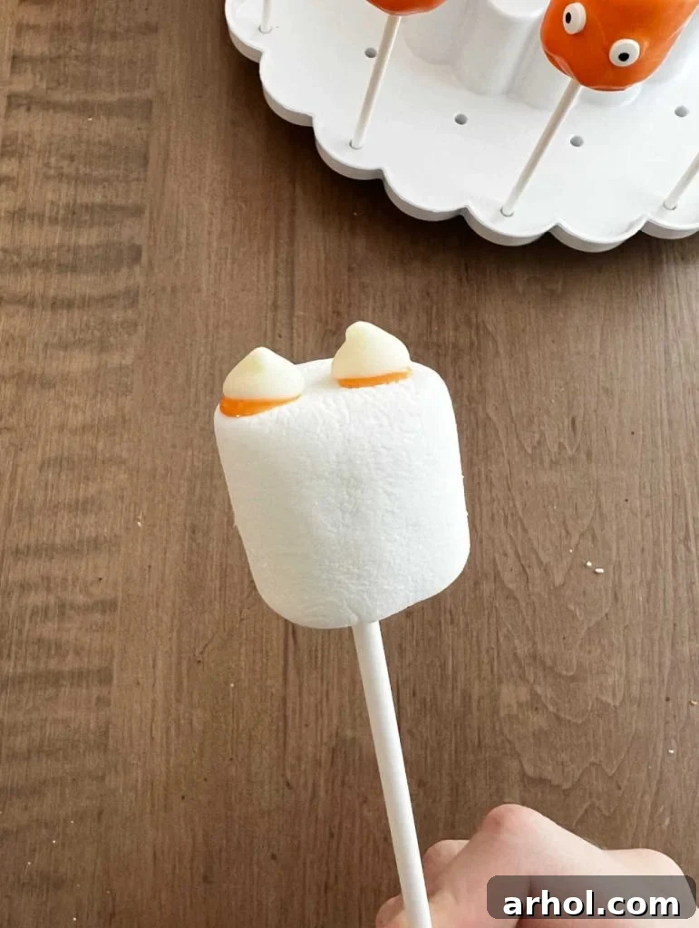 chocolate chip ears on cat marshmallow pop.