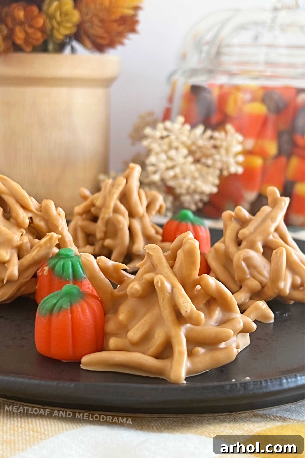 Delightful no-bake haystack cookies adorned with butterscotch morsels and marshmallow pumpkins, arranged beautifully on a plate, ready for a fall celebration.