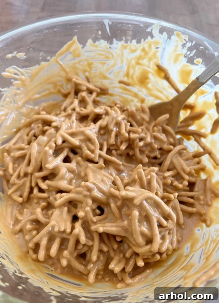 Crunchy chow mein noodles perfectly coated in a luscious butterscotch and peanut butter mixture, ready to be formed into delicious haystacks.