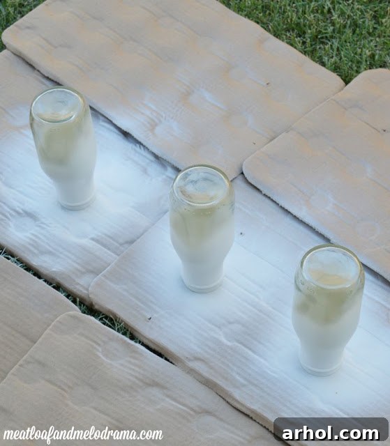 Glass bottles with white spray paint applied to the top section