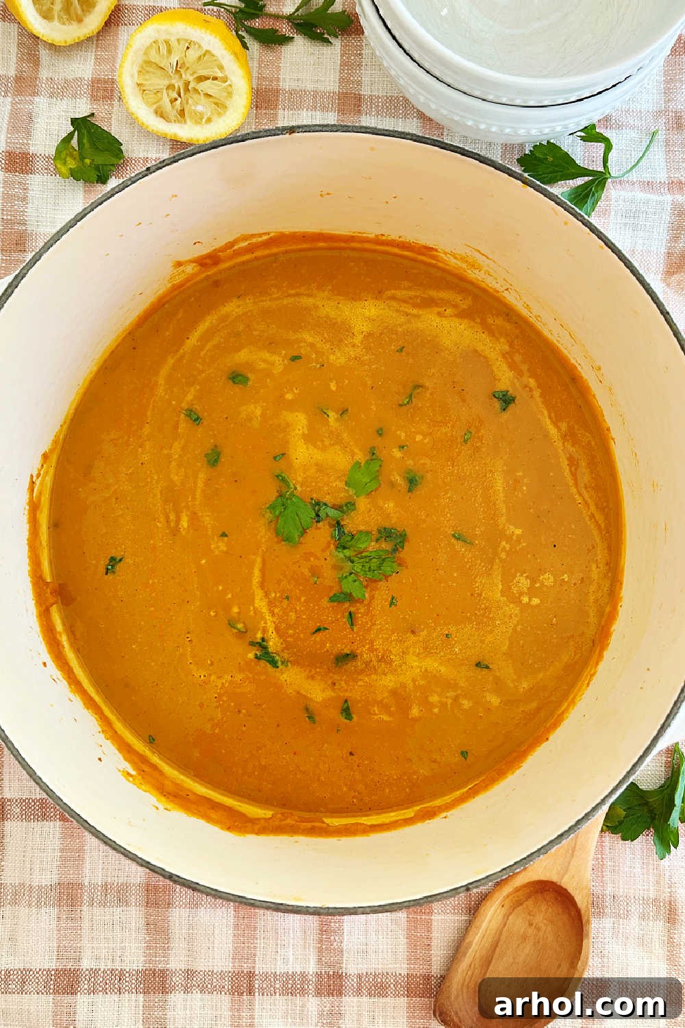 A pot of finished Libby's canned pumpkin soup sitting in a Dutch oven on a stovetop, ready for serving.