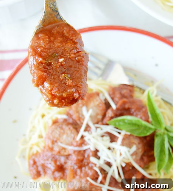 A vibrant bowl of homemade marinara sauce with Italian sausage, simmered to perfection, ideal for pasta dishes or dipping bread.