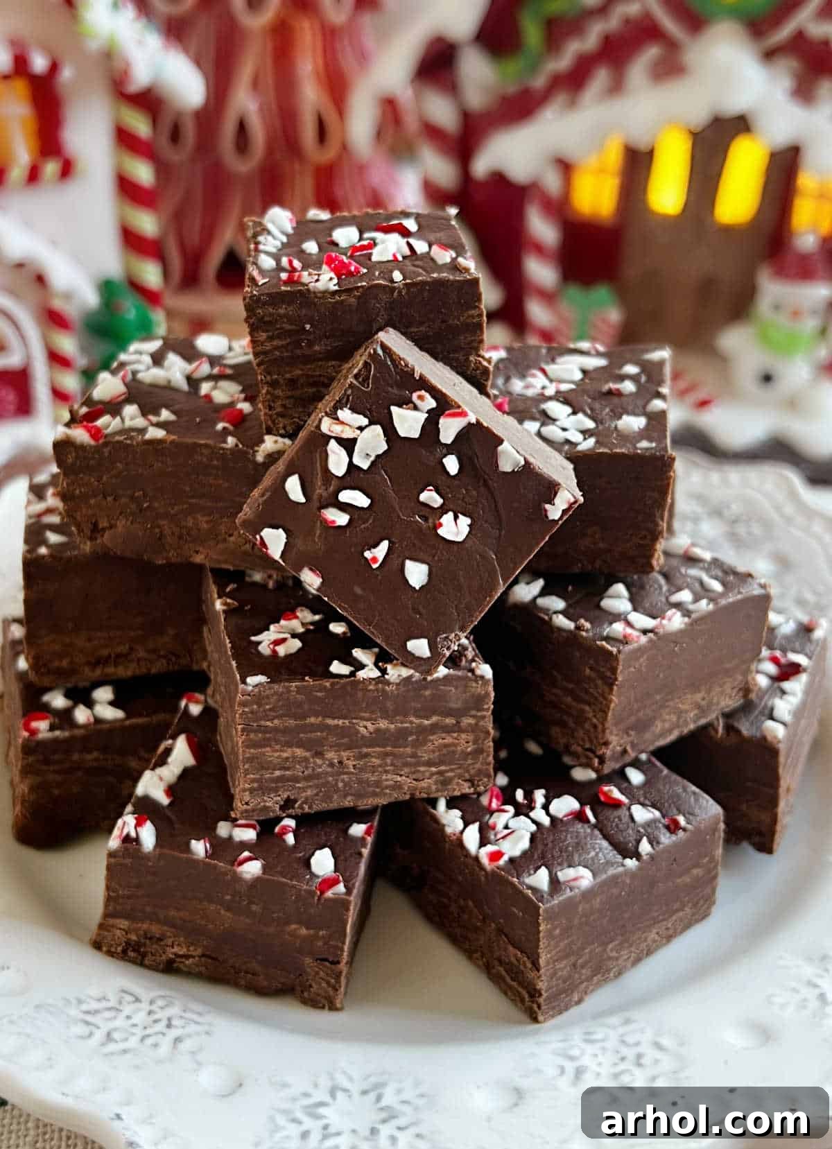 Irresistible dark chocolate peppermint fudge adorned with crushed candy canes, ready to be enjoyed as a holiday treat.