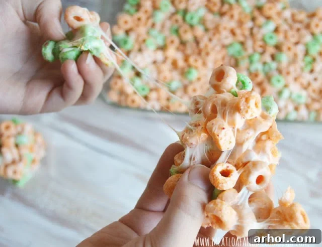 A close-up view of a single Apple Jacks marshmallow treat, highlighting its gooey texture