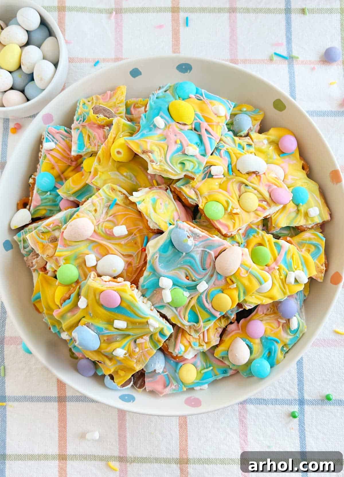 bowl of Easter bark with mini eggs, marshmallow bits, sprinkles and pretzels.