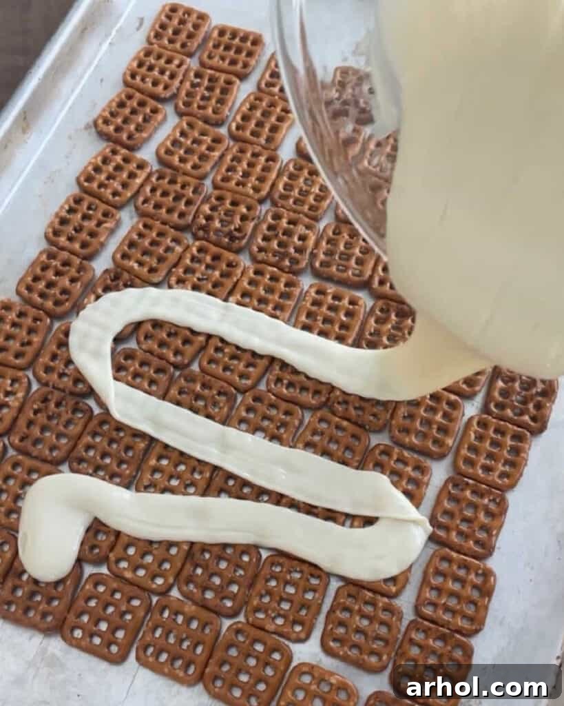 pour melted white chocolate over pretzels.