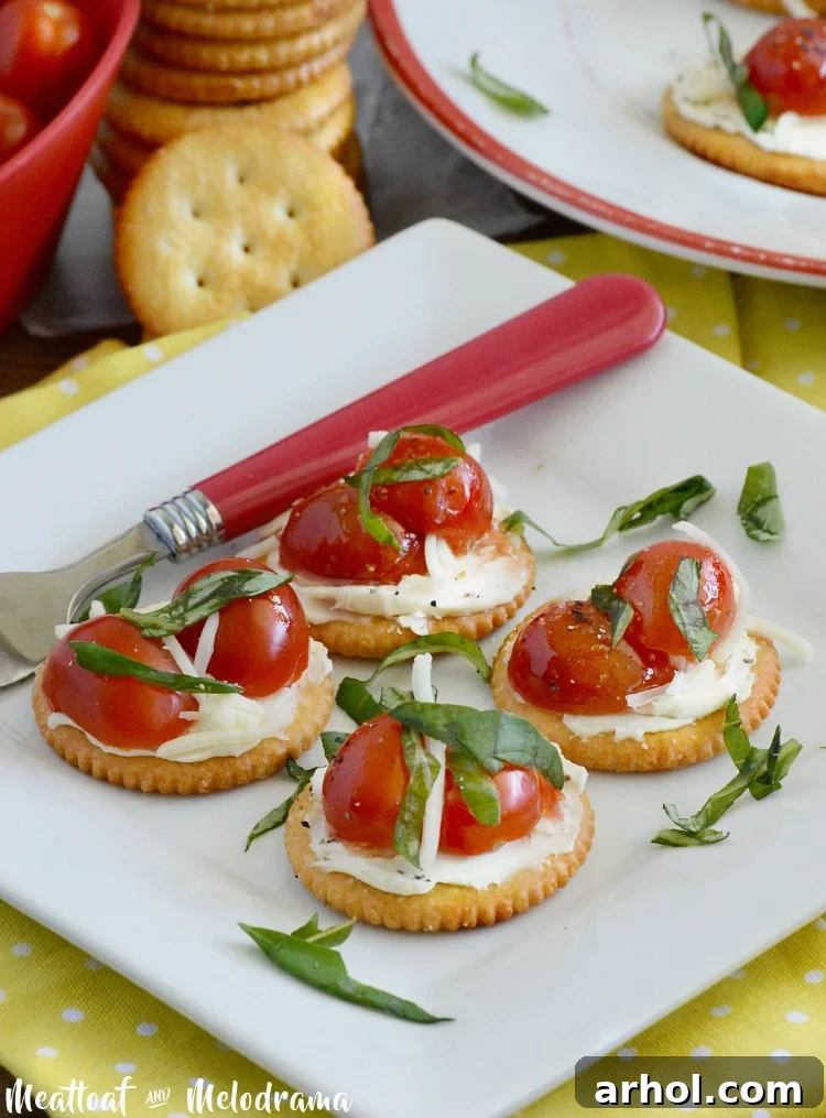 Caprese RITZ cracker appetizers with cream cheese, grape tomatoes, and fresh basil