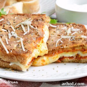 Parmesan Crunch Pepperoni Pizza Melt 2 Parmesan crusted pepperoni pizza grilled cheese sandwich on plate