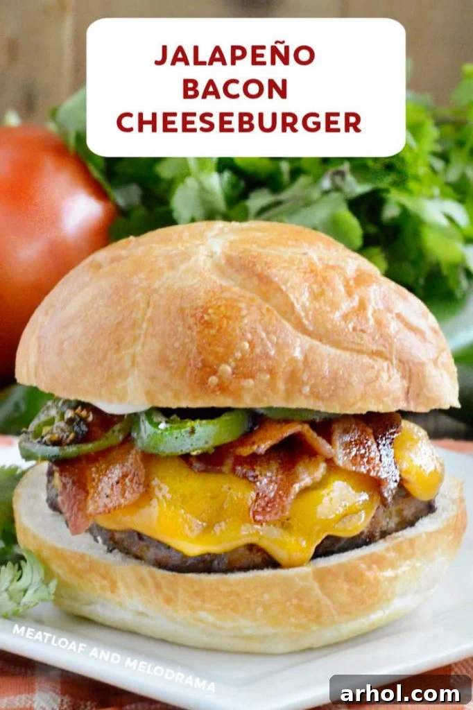 close up of cheeseburger with sliced jalapeno peppers and bacon