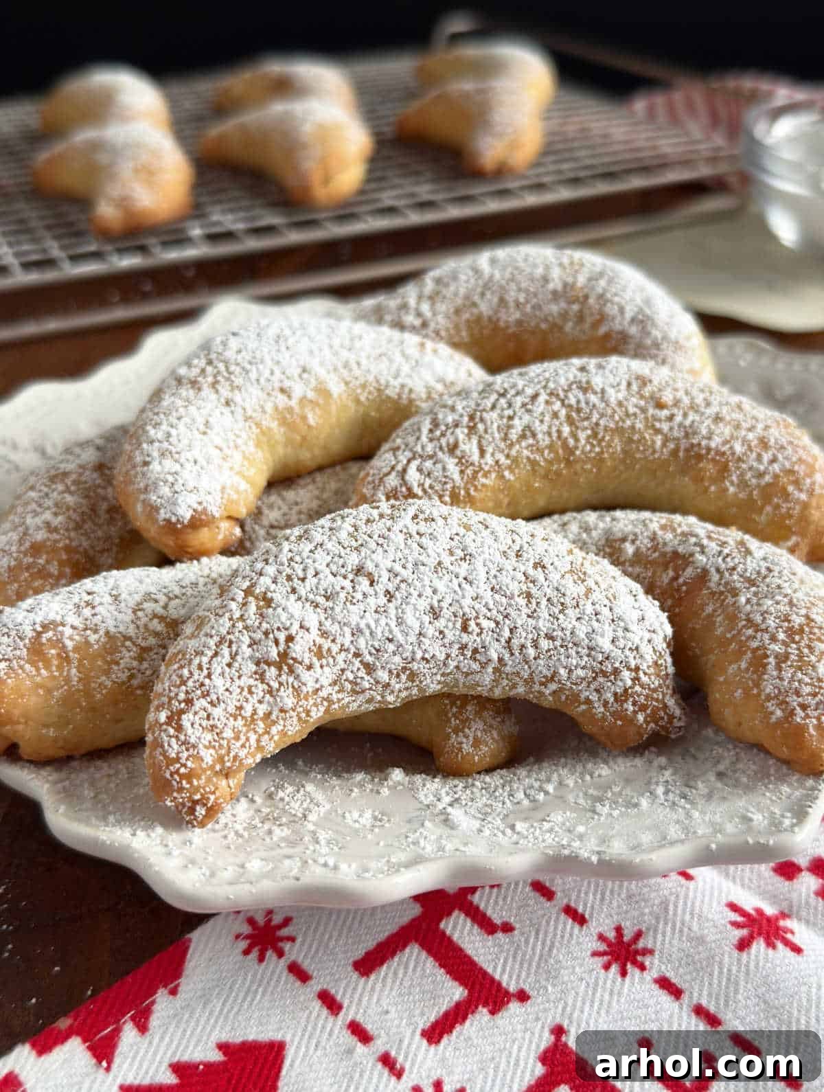 A small pile of perfectly baked Rosky nut horns on a clean white plate, ready for serving.