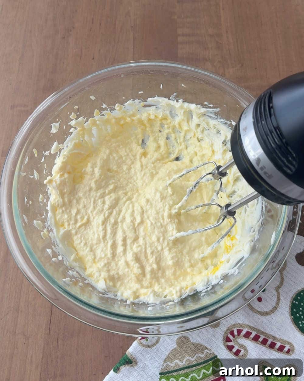 Creaming butter and sugar in a mixing bowl with an electric mixer, showing the light and fluffy texture.