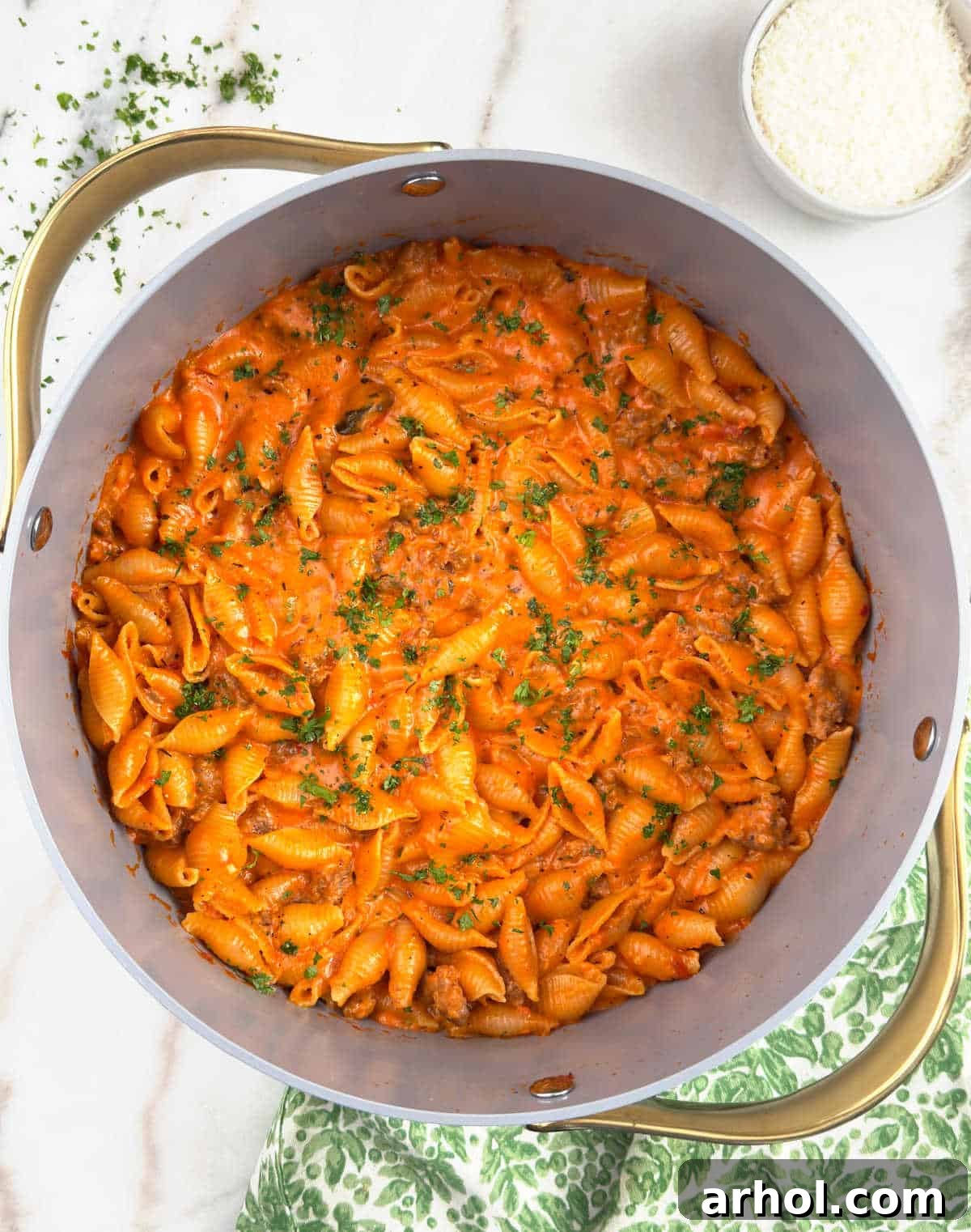 A vibrant dish of one-pot creamy Italian sausage and shells pasta, garnished with fresh parsley.