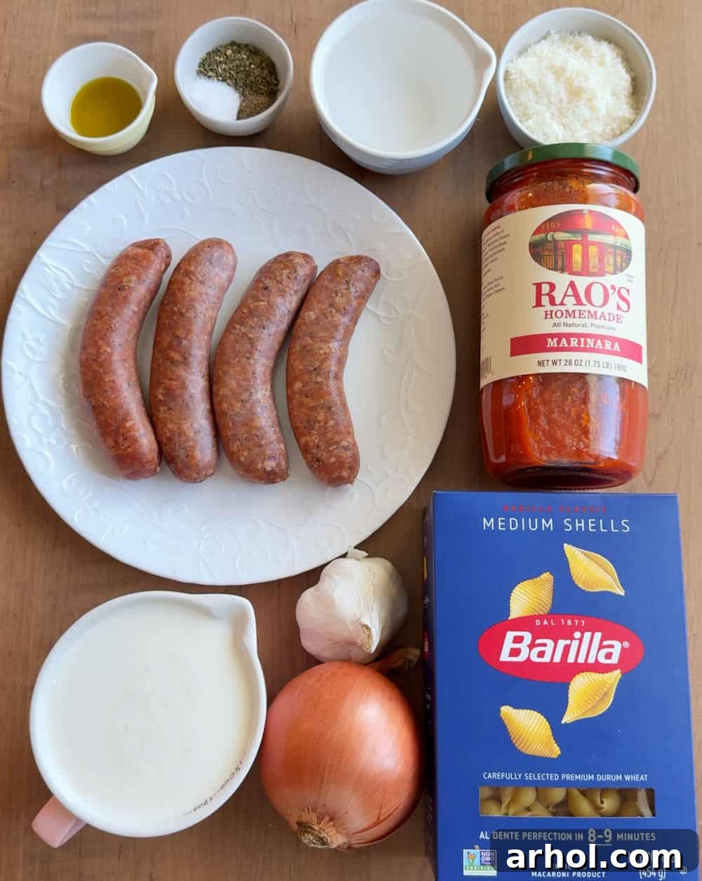Ingredients for one-pot creamy sausage and shells: Italian sausage, marinara sauce, medium shells, Parmesan cheese, onion, garlic, spices, heavy cream.