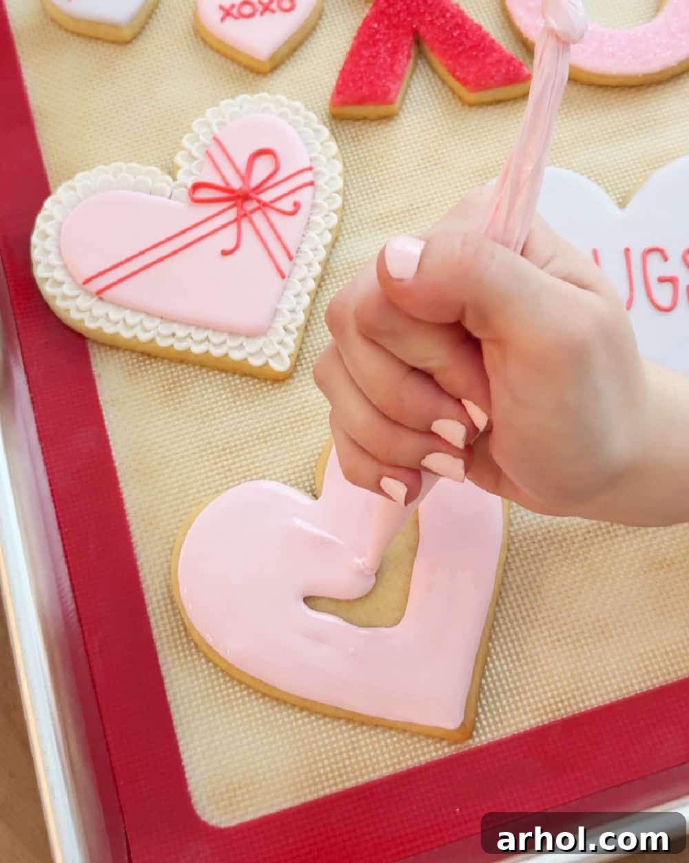Piping icing onto cookies.