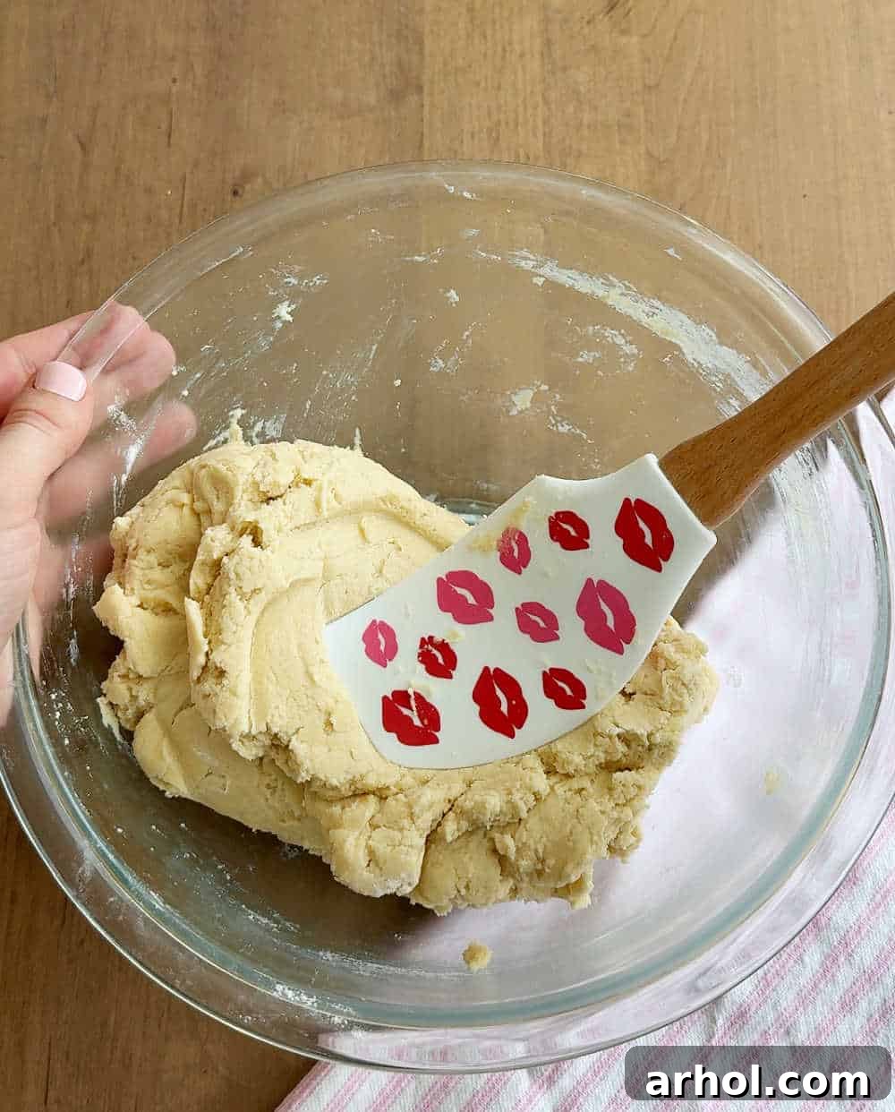 Pressing spatula into dough.