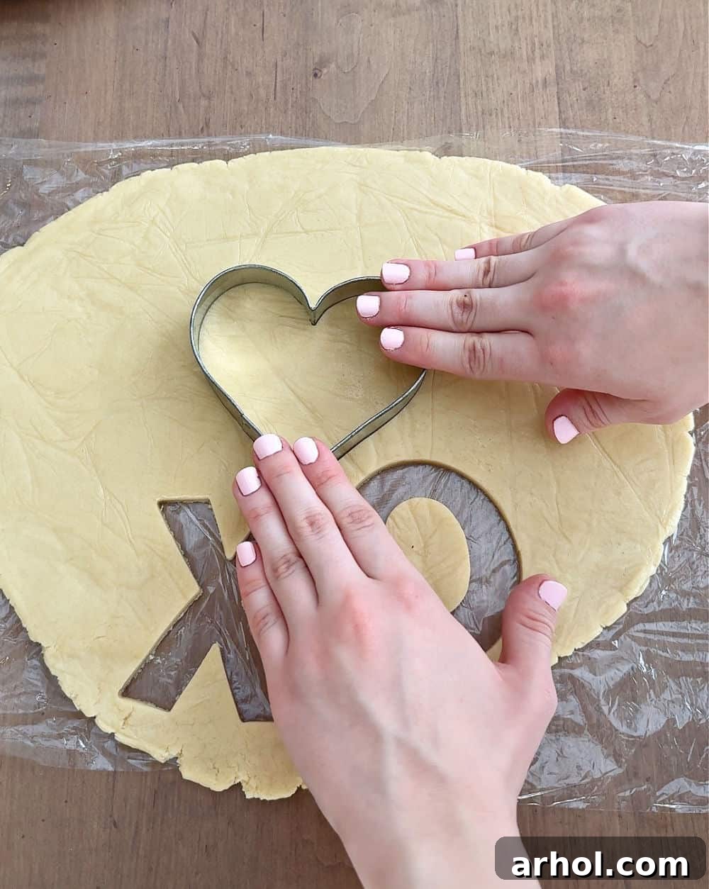 Cutting out shapes with cookie cutters.