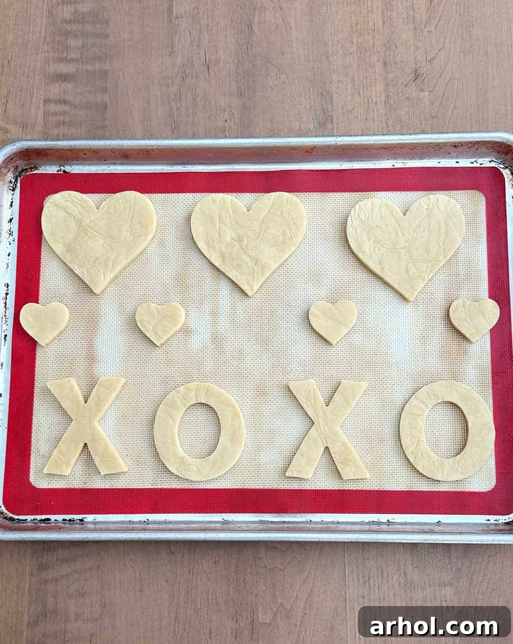 Cut out cookie dough on baking sheet.