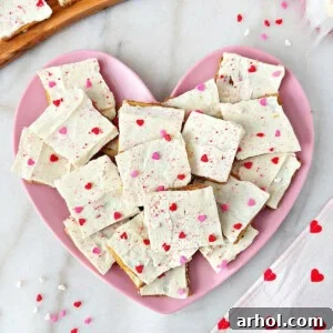 A beautifully arranged plate of Valentine's Day crack candy, adorned with festive sprinkles.