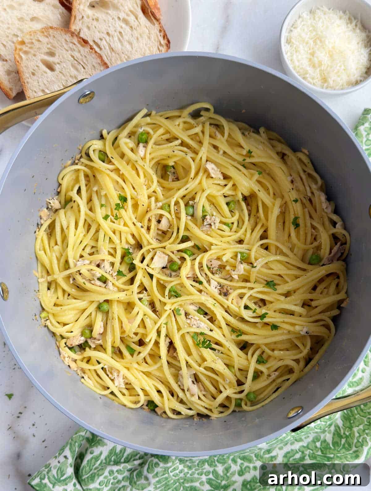 Cooked pasta with tuna and peas in a Dutch oven, ready to be served.