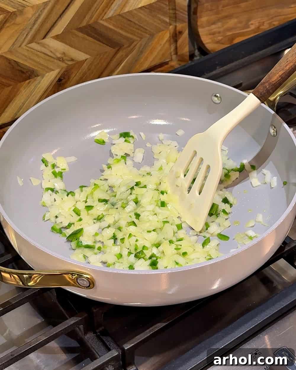 Sautéing diced onion and jalapeño in olive oil in a hot skillet until softened.