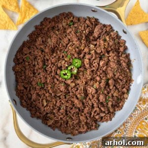 Close-up shot of seasoned ground beef taco meat in a white bowl, ready to be served. Ideal for a recipe pin.