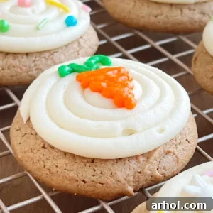 Soft and chewy carrot cake mix cookies generously topped with homemade cream cheese frosting and a cute, tiny iced carrot decoration.