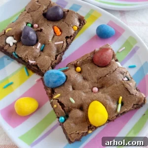 Rich and fudgy Easter brownies adorned with colorful Cadbury mini eggs and festive sprinkles, making a cheerful holiday treat.