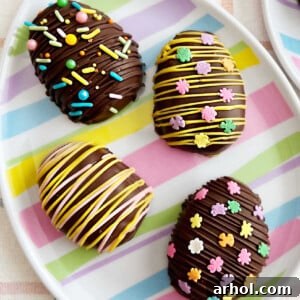 Homemade chocolate-covered peanut butter eggs, beautifully decorated with festive Easter drizzles and sprinkles.