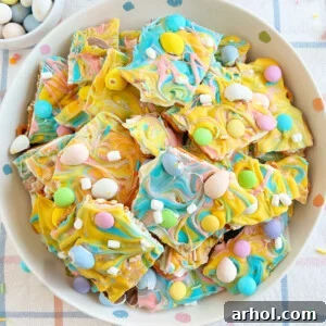 A festive Easter bark with delicate pastel colors, studded with mini candy eggs, crunchy marshmallow bits, and savory pretzels, creating a perfect balance of sweet and salty.
