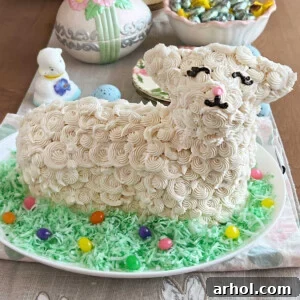 A beautifully decorated Easter lamb cake with buttercream frosting, colorful coconut, and jelly beans, making an adorable and festive centerpiece for Easter Sunday.