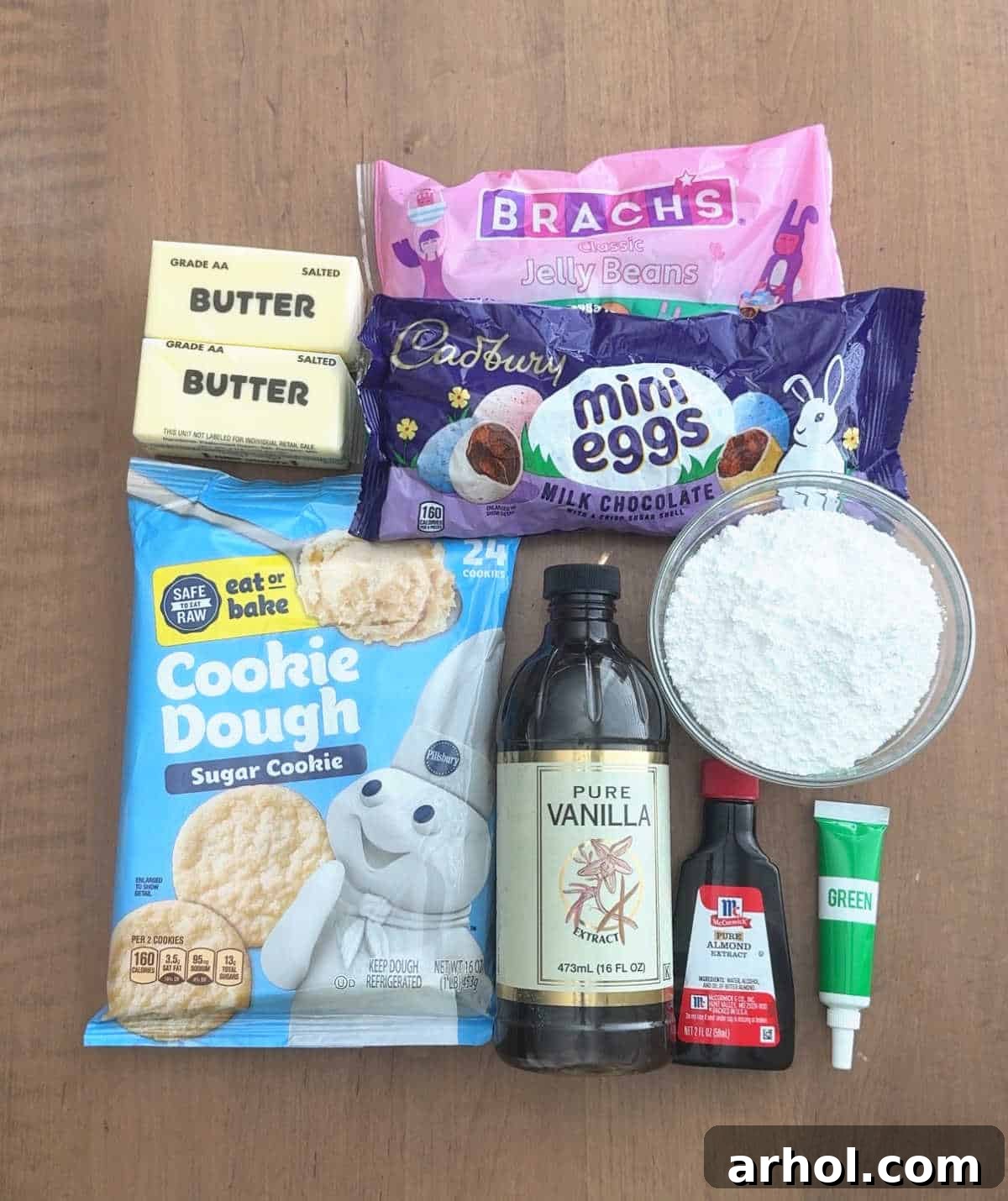 Adorable Easter Cookie Basket Nests 4 A flat lay of ingredients for Easter basket cookie cups: cookie dough, butter, candy, vanilla extract, sugar, and food coloring.