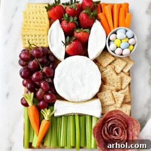 Delightful Easter bunny charcuterie board recipe with brie, salami, fruit, veggies, and crackers.