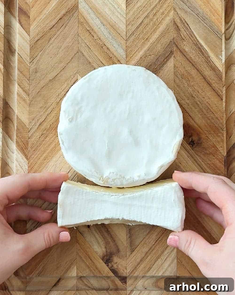 Step 2: Arranging the main wheel of brie for the bunny's head and body on the serving board, preparing for the additional pieces.