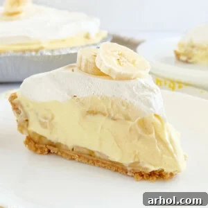 No-bake banana pudding pie in a graham cracker crust with Cool Whip on top.