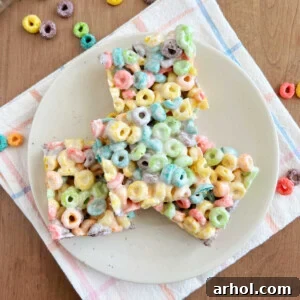 Colorful Fruit Loop bars made with Froot Loops cereal and marshmallows on a plate.