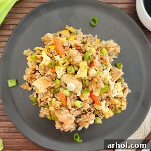 A plate of delicious Blackstone chicken fried rice with egg and mixed vegetables.