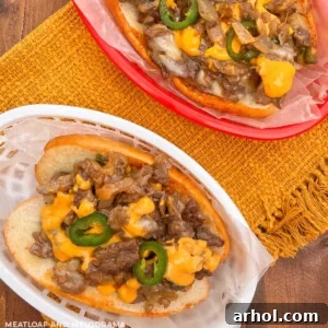Arizona Blackstone Cheesesteaks with jalapeño peppers and nacho cheese on a table.