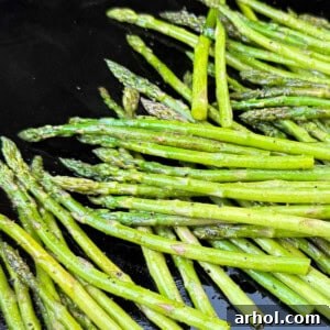 Grilled asparagus spears perfectly cooked on a Blackstone griddle.