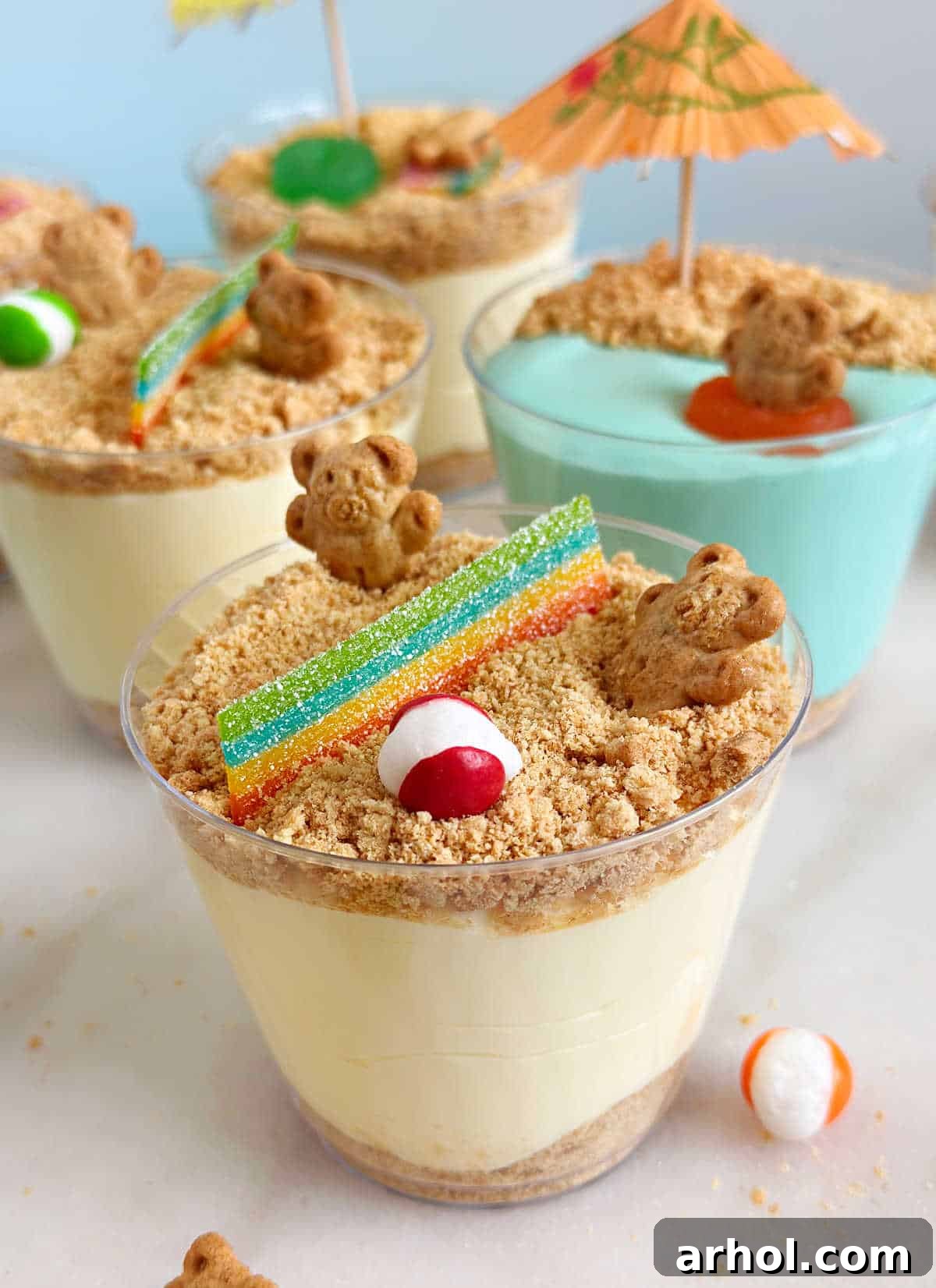 Two Teddy Graham bears playing volleyball with a net made from candy over the graham cracker sand.