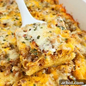 A square slice of sausage and egg breakfast casserole with sourdough bread