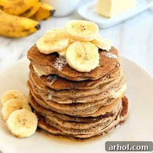 A plate with a stack of banana cinnamon pancakes